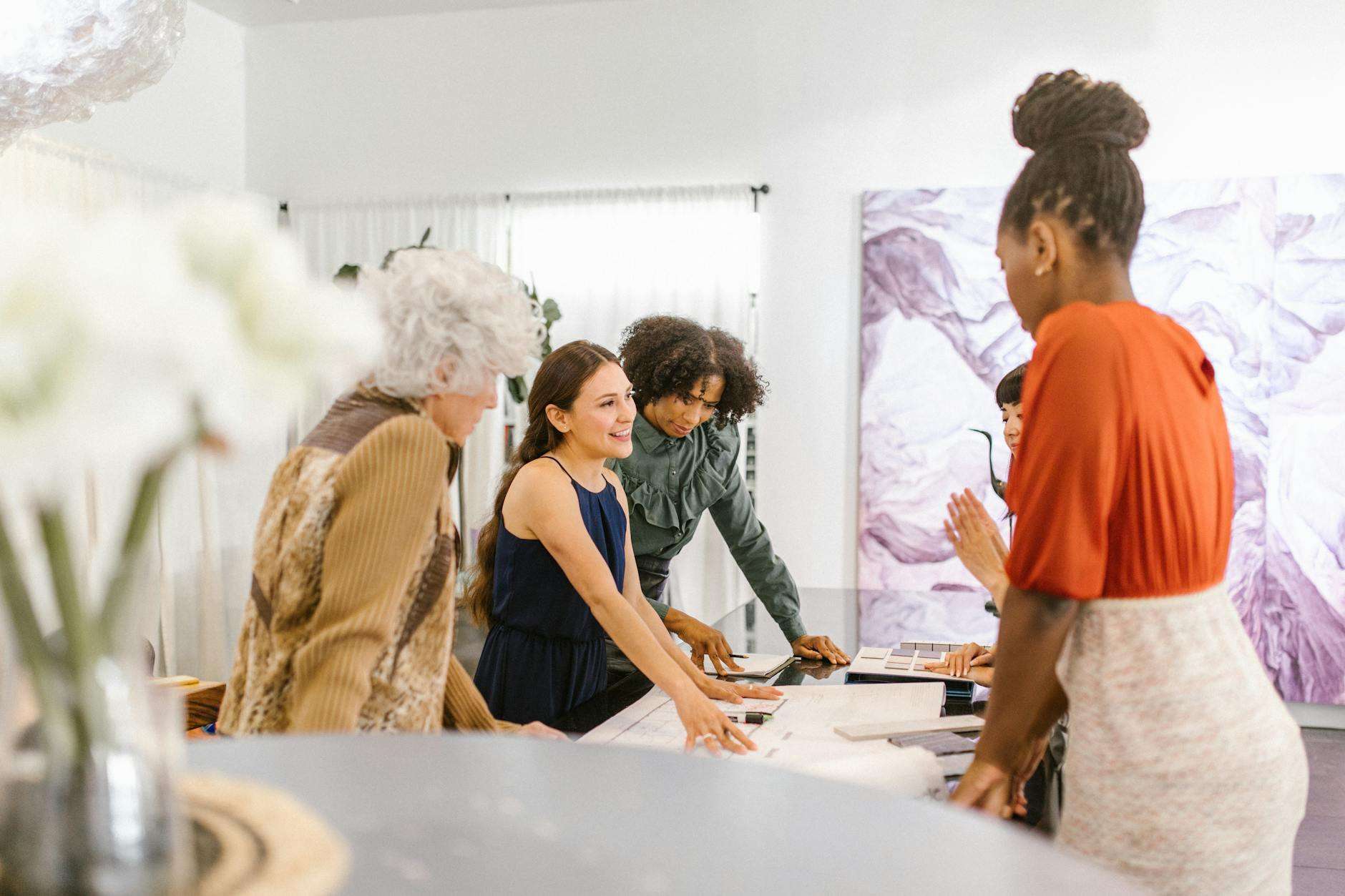 a group of women having conversation inside the office